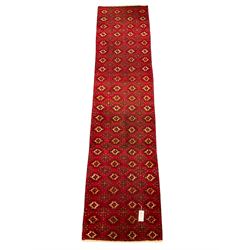 Persian red ground runner, decorated all over with geometric and star motifs