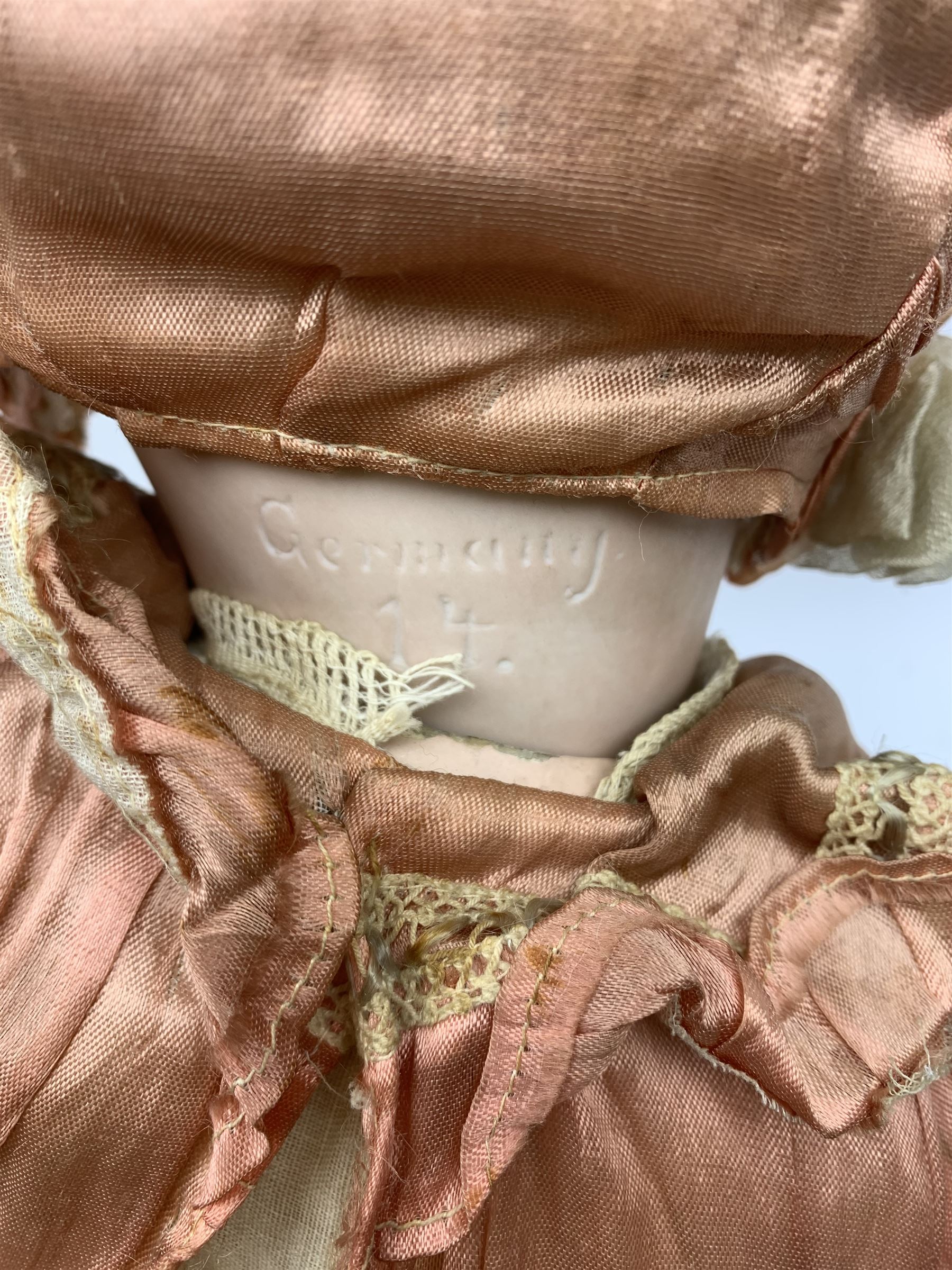 German bisque head doll with applied hair, sleeping eyes and open mouth with teeth and fixed tongue, on composition body with jointed limbs, marked 'P.M. 914 Germany 14' H65cm