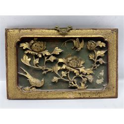 Two carved oriental wall hangings, the first example gilded depicting a temple and garden scene, the second figures in a garden, L49cm