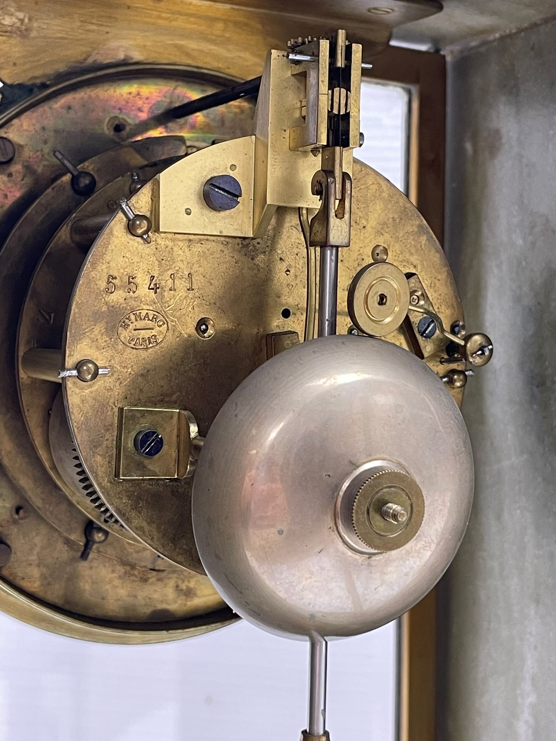 French - Late 19th century 8-day white marble and gilt metal portico clock garniture, the clock surmounted by an urn and raised on a pair of cylindrical pillars above a rectangular plinth base, white enamel dial with Arabic numerals and floral garlands, twin train countwheel striking movement, striking the hours and half hours on a bell, with a sunburst pendulum and gilt Louis XVI hands, garniture with matching twin light candelabra. With Key.   Candelabra H 30cm.