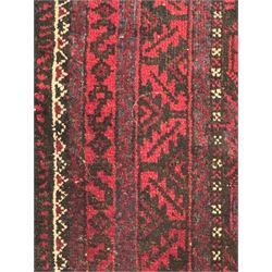 Turkoman red ground wool rug, the field with a repeating pattern of Tekke gul motifs in dark brown and red (195cm x 98cm); Afghan Bokhara red ground wool rug, central field with repeated geometric octagonal gul motifs, surrounded by multiple borders with stylised diamond and triangular patterns (127cm x 181cm)