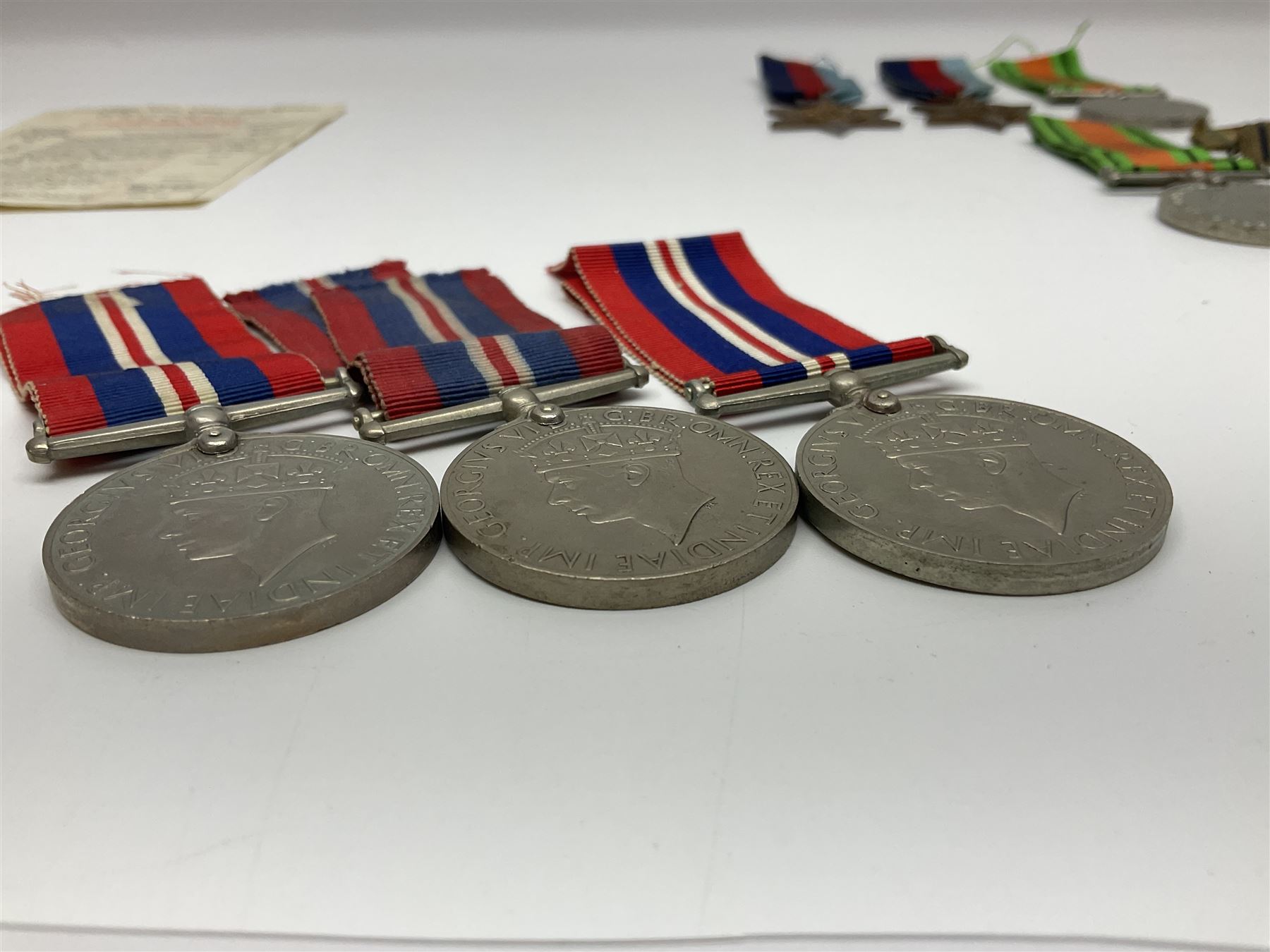 Eleven WW2 medals comprising three 1939-1945 war medals, two Defence medals, three 1939-1945 Stars, Atlantic Star, Africa Star and Italy Star; miniature QEII Naval LS & GC medal; all with ribbons; and WW2 postumous medal slip to Flight Sergeant L.N. Clark