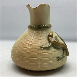 Royal Worcester blush ivory basket weave ewer, the vase of bag shape with twisted rope to the neck decorated with applied decoration of orange and green gilt-heightened lizard and naturalistic sectioned bamboo handle, with stamped puce marks and no 1714 beneath, H15cm