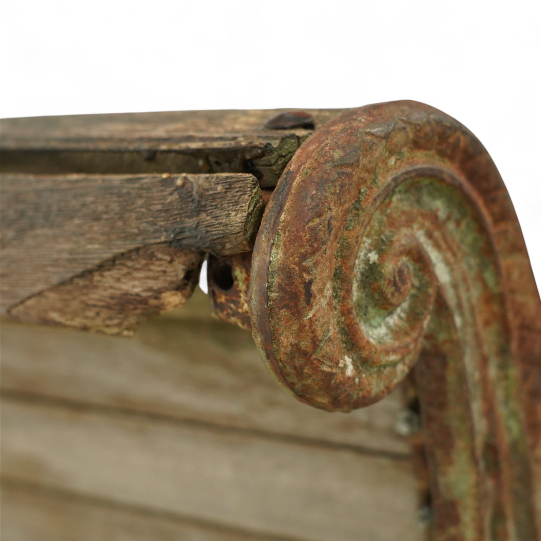 19th century oak and cast iron garden bench, shaped back and seat formed from curved wooden slats secured with dome rivets, pierced cast iron supports with foliate decoration 