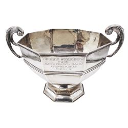 Large Edwardian silver trophy cup, of octagonal waisted form, the body with personal engraving, with twin capped bifurcated scroll handles, upon conforming octagonal stepped foot, hallmarked William Hutton & Sons Ltd, London 1908, H22.5cm