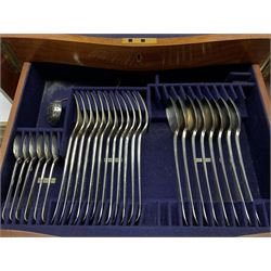 Late 19th/early 20th century composite canteen of silver flatware, contained within an early 20th century mahogany serpentine fronted case with twin drop carry handles, and hinged cover with boxwood stringing and central inlaid shell motif, above a single drawer with twin ring handles and Wellington style locking system, the cover and drawer opening to reveal plaque for Spink & Sons Ltd London, and fitted interior containing ivory handled knives, ivory handled carving set, and silver Hanoverian and Old English pattern cutlery, each with engraved monogram to terminal, hallmarked London, makers Spink & Son (John Marshall Spink), Goldsmiths & Silversmiths Co, and Chawner & Co (George William Adams), various dates ranging 1880-1923, gross weighable silver 92.59 ozt (2880 grams)