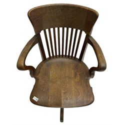 Early 20th century swivel office desk chair, shaped bar back over vertical rails, dished seat, on four splayed supports