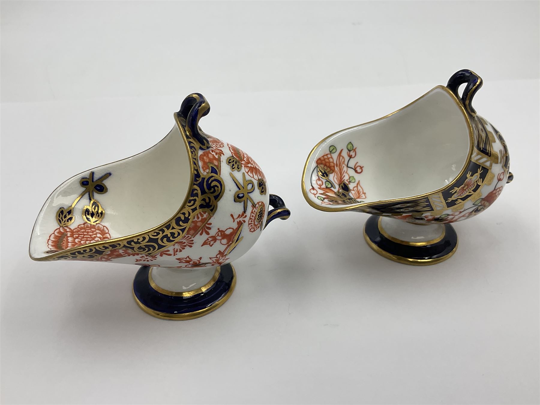 Group of Crown Derby and Royal Crown Derby Imari pattern miniatures, including mid 19th century Stevenson and Hancock cauldron, with painted mark beneath, H5.5cm, a near pair of early Royal Crown Derby scuttles, decorated in the 6299 pattern, each with printed and painted marks beneath including illustration date codes for 1913 and 1922, tallest 6.5cm, and a further early 20th century Royal Crown Derby scuttle, decorated in the 6299 pattern, with printed and painted marks beneath including illustration date code for 1922, H5.5cm, (4)
