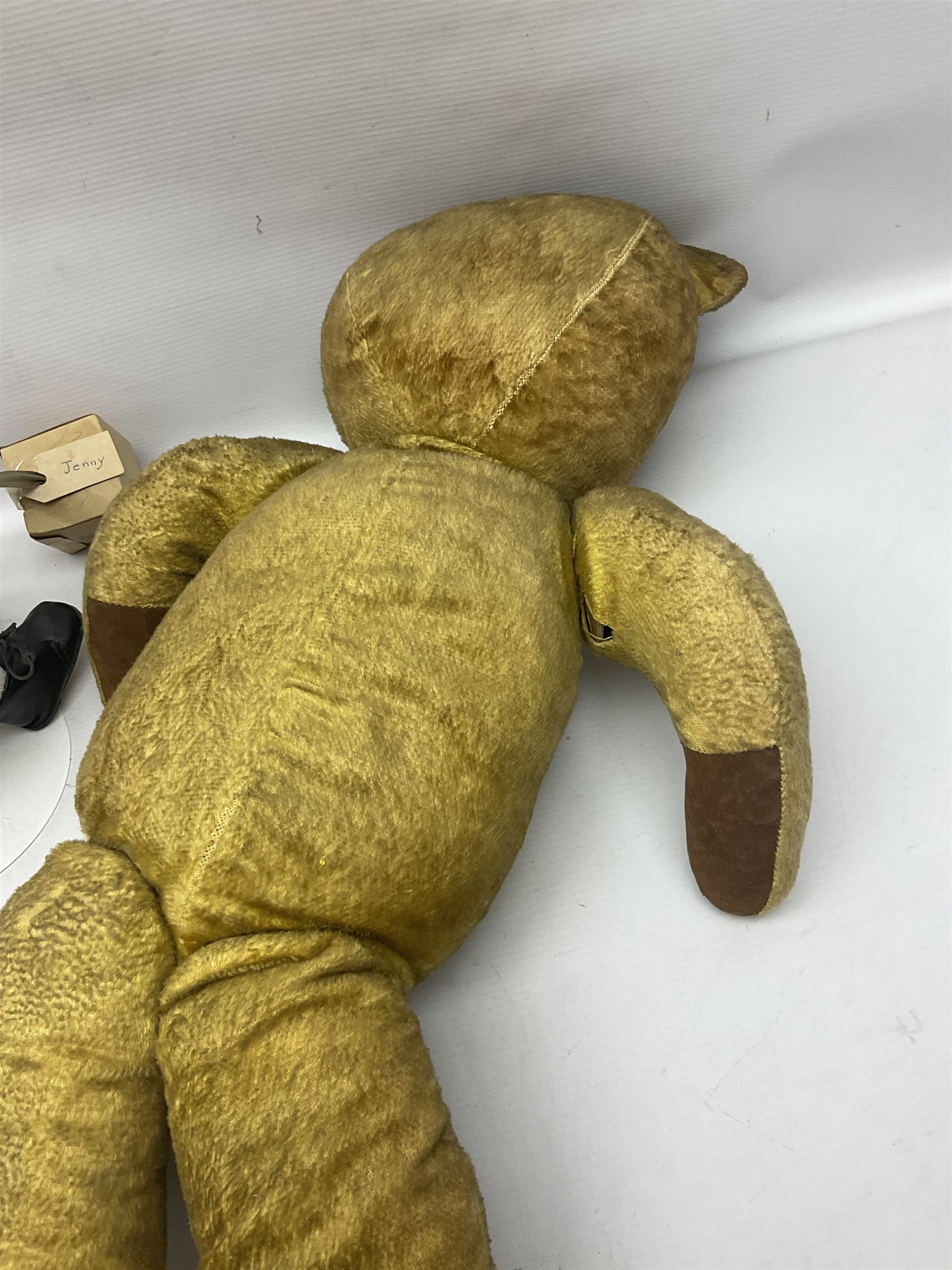 Mid-20th century woodwool filled teddy bear; and porcelain doll dressed as a WW2 evacuee