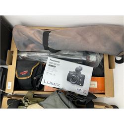 Large quantity of camera equipment in three boxes - Lumix GX1 camera, Canon EOS 500 camera, Lumix FZ100 camera, Pantax  MZ5n, various other cameras, Swift spotting Scope 20 x 60 in box,  Maxtor hard drive, three tripods, Kodak carousel projector, Pradolux slide projector, a selection of camera bags and other camera equipment. 