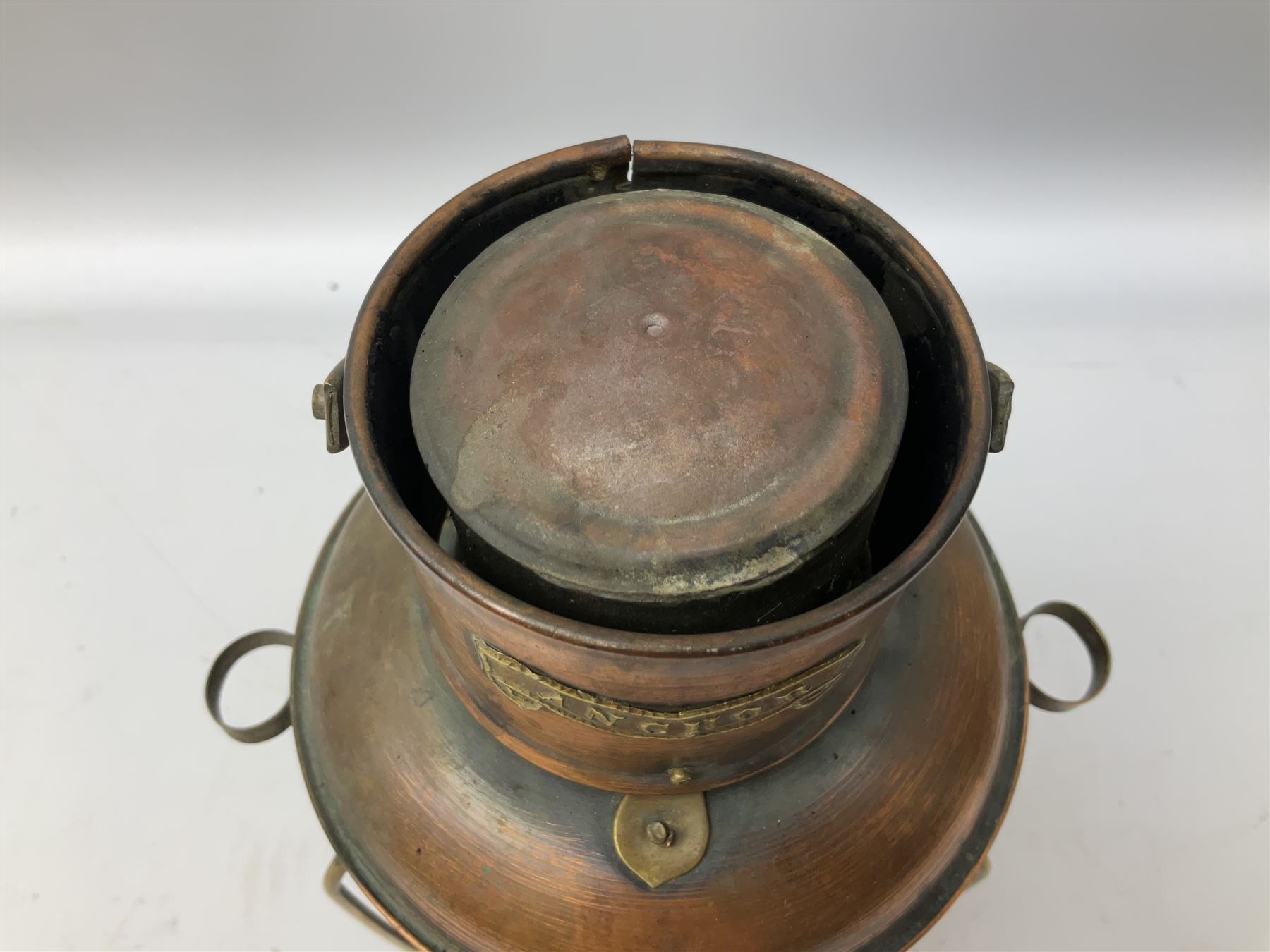 Copper and brass ship’s lamp marked ‘Anchor’, H25cm, Feuer hand storm lantern, Bialaddin Model 315 paraffin lamp and an Anchor lamp (4)