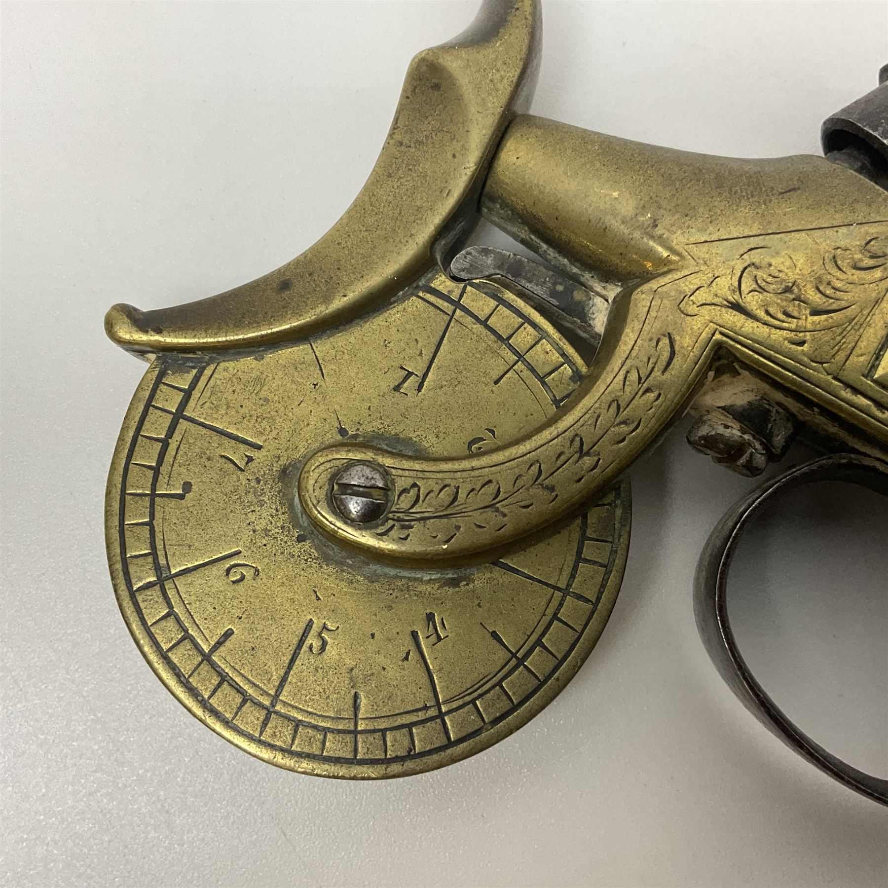 19th Century percussion eprouvette or gunpowder tester, with foliate engraved brass box lock and calibrated ratcheted wheel, steel trigger guard and walnut bag butt, L14cm