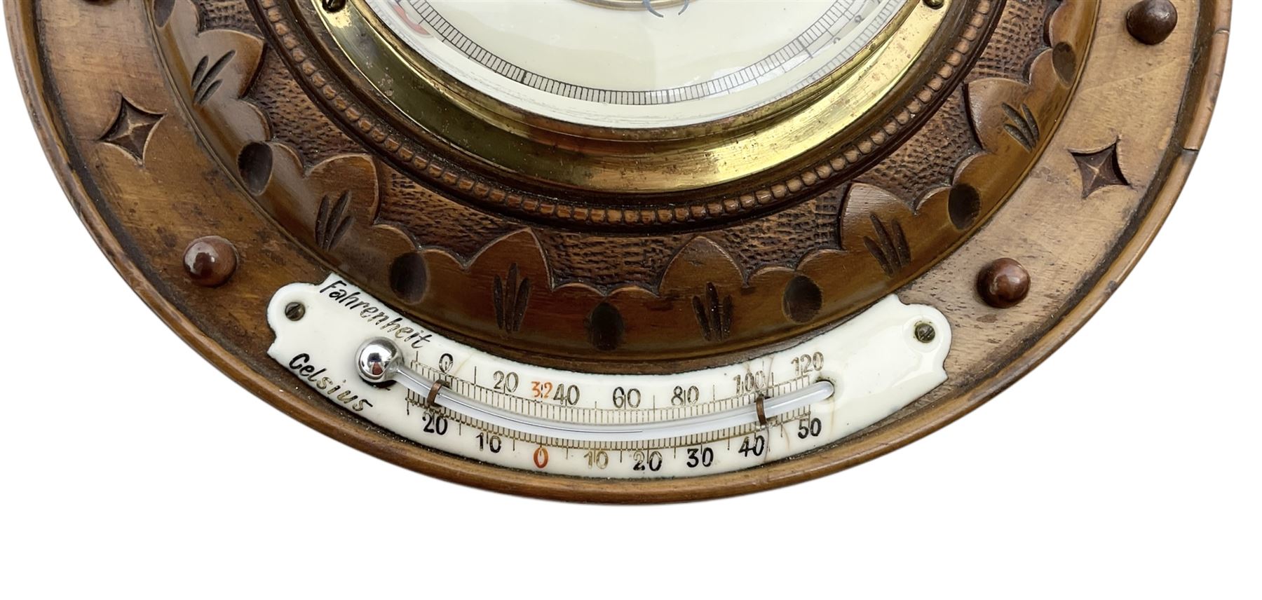 German- Late 19th century aneroid Barometer in a carved mahogany case with pendants and finials, 4” open dial register and mercury thermometer, with another early Edwardian aneroid barometer in a circular carved  walnut case with a 4