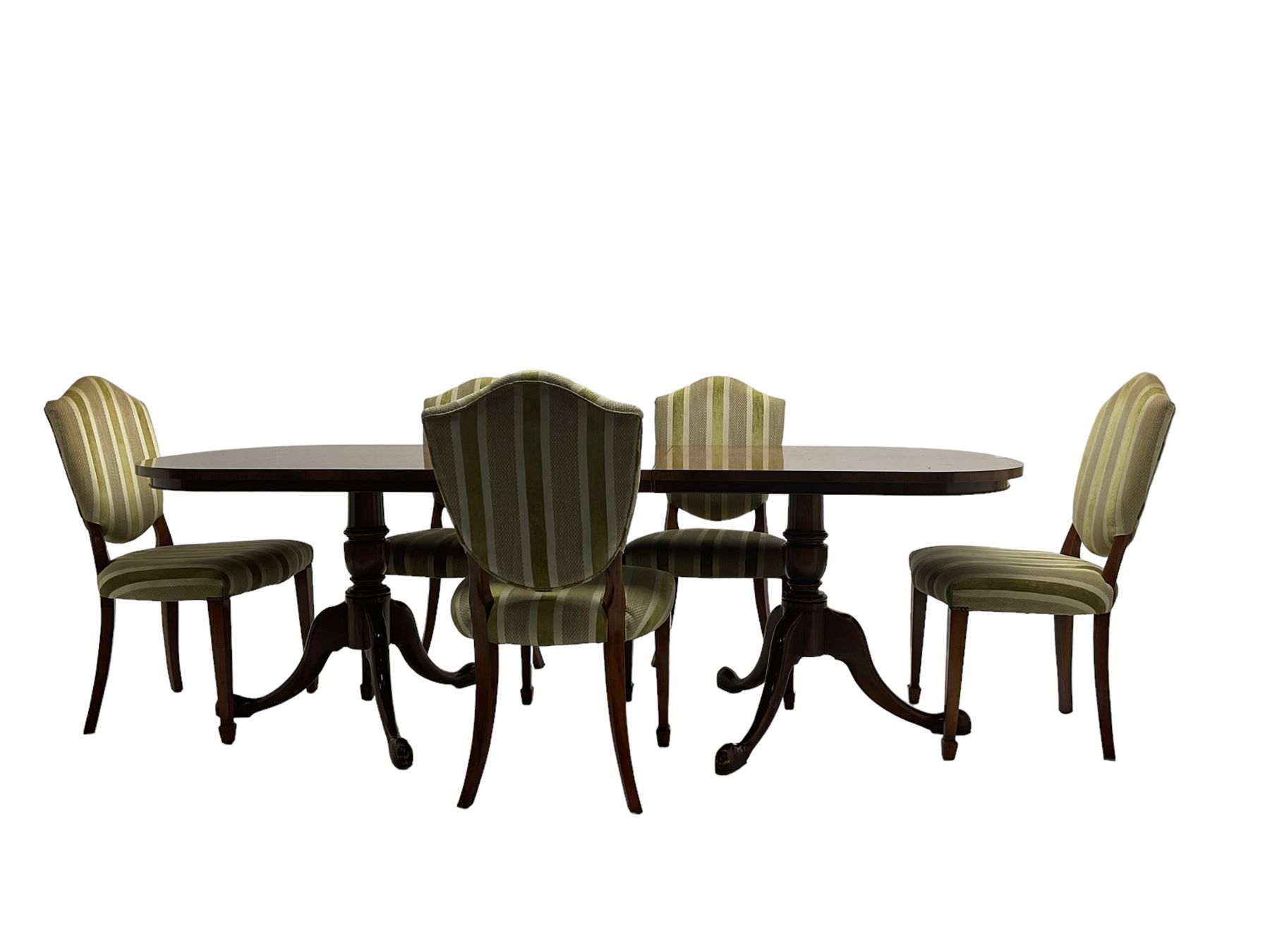 Regency design walnut twin pedestal extending dining table, rectangular burr top with rounded corners and crossbanding, raised on turned vasiform columns with tripod base, with additional leaf (D107cm W184cm/230cm, H76cm); and set eight (6+2) shield back dining chairs, upholstered in striped laurel green fabric, raised on tapering supports with spade feet, retailed by Geoffrey Benson