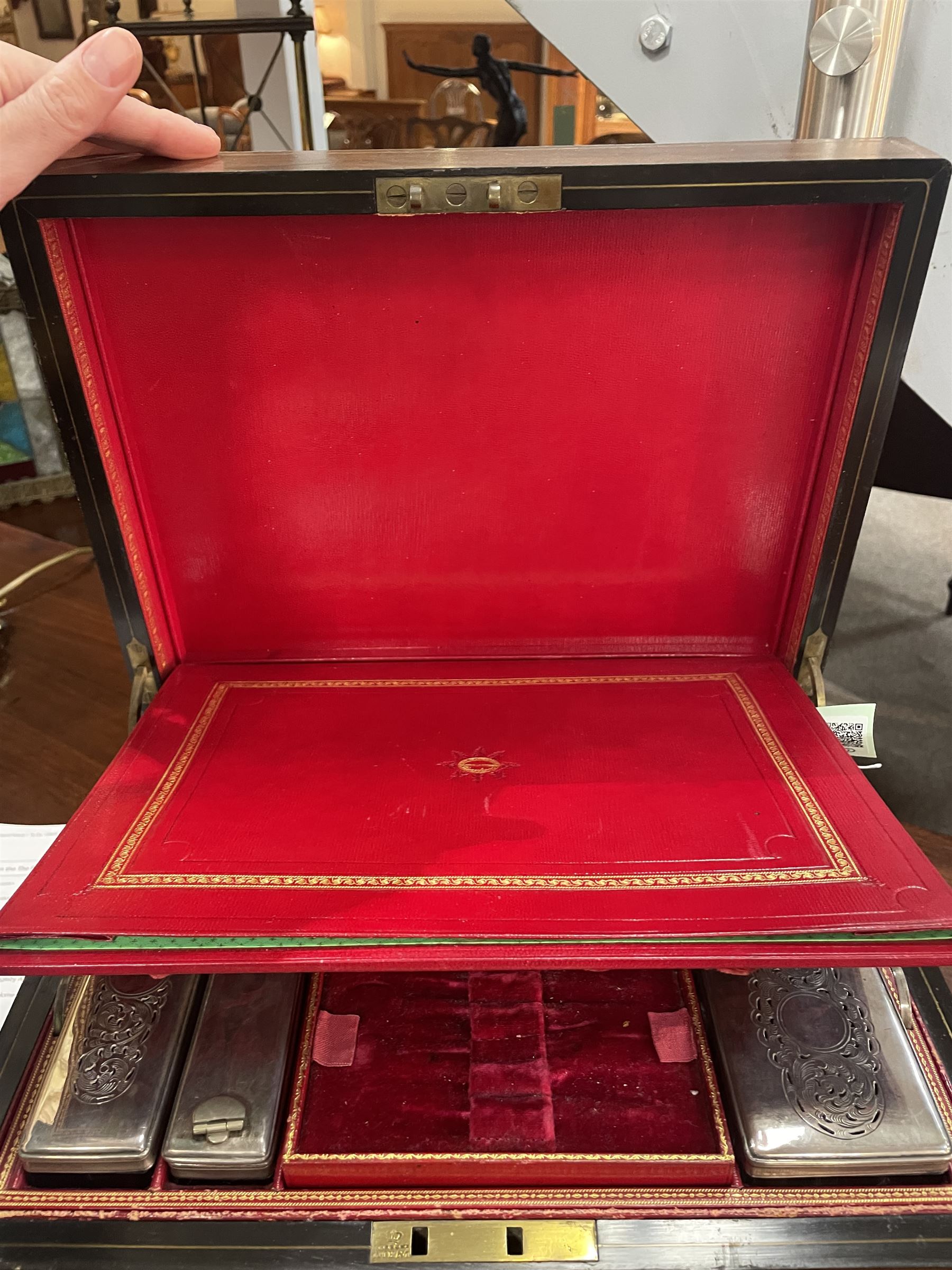  Victorian brass inlaid rosewood dressing table box, retailed by F.L. Hausburg, Liverpool, the lid centred by a brass cartouche, opening to reveal letter store to lid underside, above a fitted interior, with ten mounted cut glass jars, bottles and manicure set, within lift out leather trays, above jewellery drawer, with key, H17cm D24cm