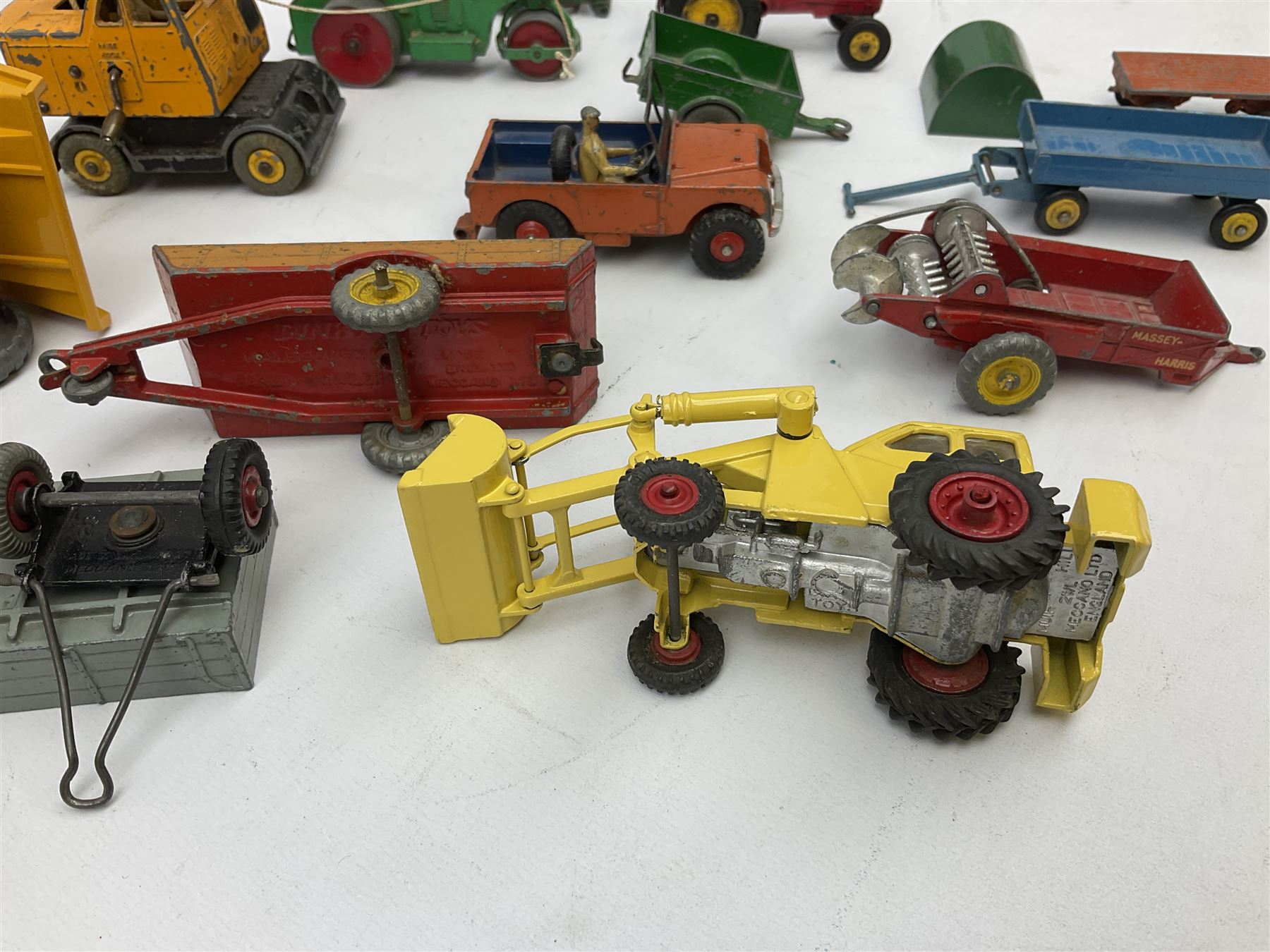 Dinky - nineteen unboxed and playworn/repainted die-cast models including Muir Hill Dumper, Muir Hill 2WL and Heavy Tractor; all repainted; Coles Mobile Crane, two Aveling-Barford steam rollers; Massey-Harris tractor and manure spreader; Land Rover; nine various trailers etc (19)