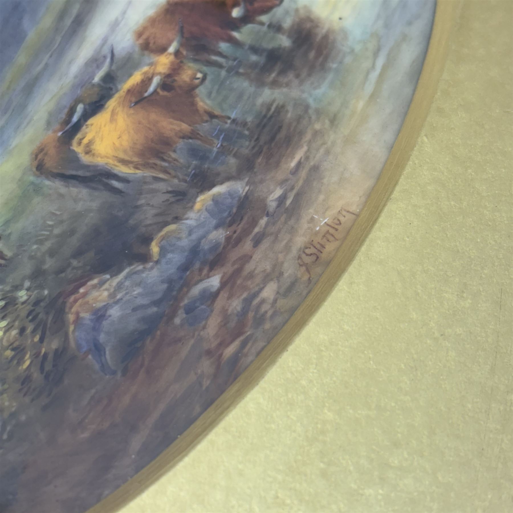 Pair of turn of the century Royal Worcester oval porcelain plaques painted by John Stinton, the first example depicting highland cattle watering against misty mountains, titled 'Loch Lomond' verso, the second depicting cows watering before a bridge with church in the distance, titled 'Bakewell Bridge Derbyshire', each signed J Stinton, each with puce printed mark verso, and date codes for 1899 and 1900, each contained within gilt frame with mount, plaques approximately 14.5cm x 23cm, overall 29.5cm x 38cm