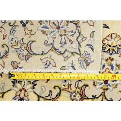 West Central Persian Sarough hand-knotted rug, ivory field with central lobed medallion issuing an all-over design of scrolling vines, palmettes, and floral sprays within conforming spandrels enclosed by a complementary foliate border flanked by guard stripes, with cotton fringe ends 