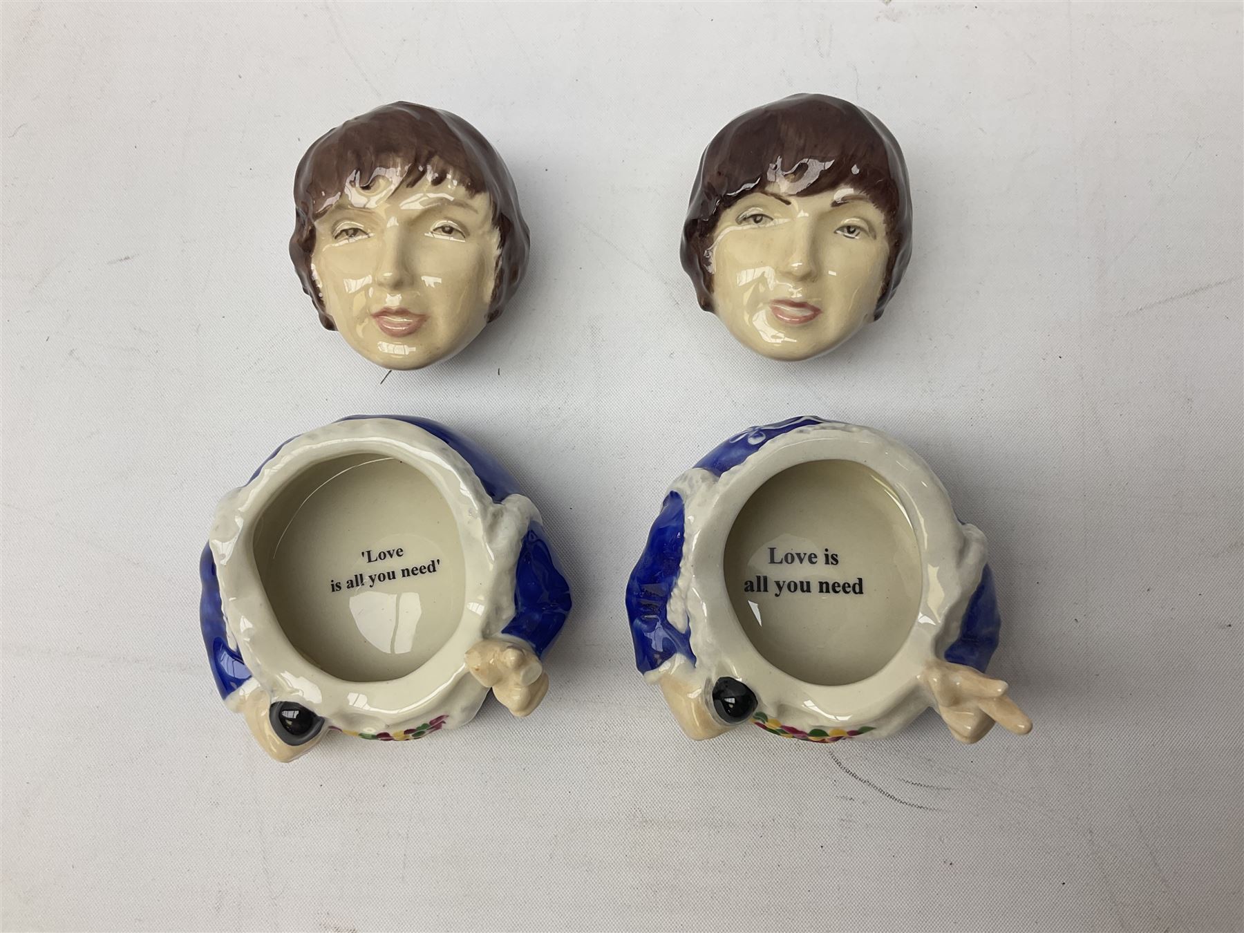 Fifteen Face Pots by Kevin Frances, all of music interest, to include the Beatles; Paul 'Kookoocachu', 'Love Is All You Need', 'Octopus's garden', 'While My Guitar Gently Weeps', 'All You Need Is Love' and 'Everybody's talking and no one says a word', Elton John; I'm still standing, Buddy Holly; 'That will be the day', David Bowie 'We can be heroes' , Mick Jagger prototype colour type etc, all boxed  