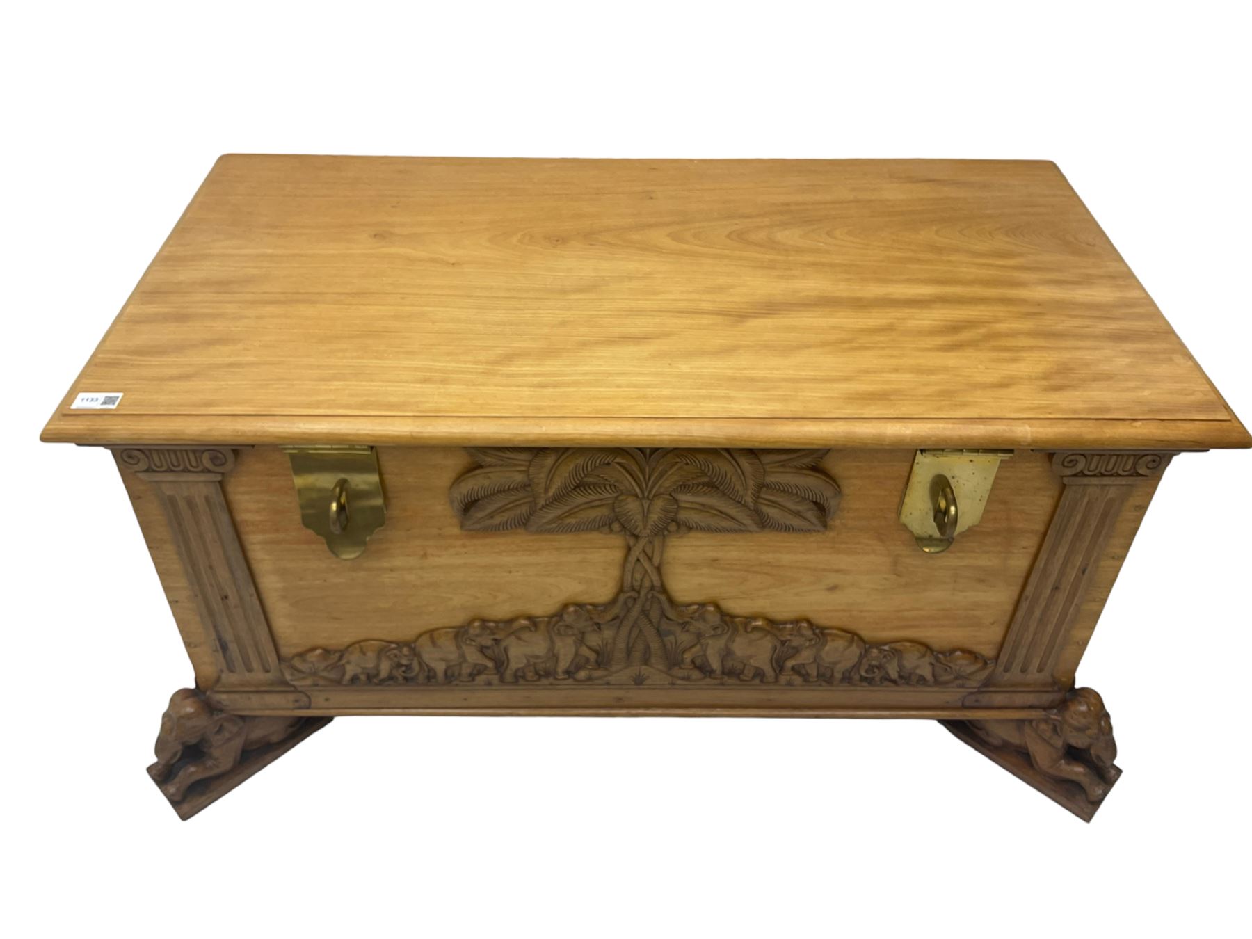 India camphor wood blanket box, moulded hinged lid, decorated with carved elephants and trees, on elephant carved feet