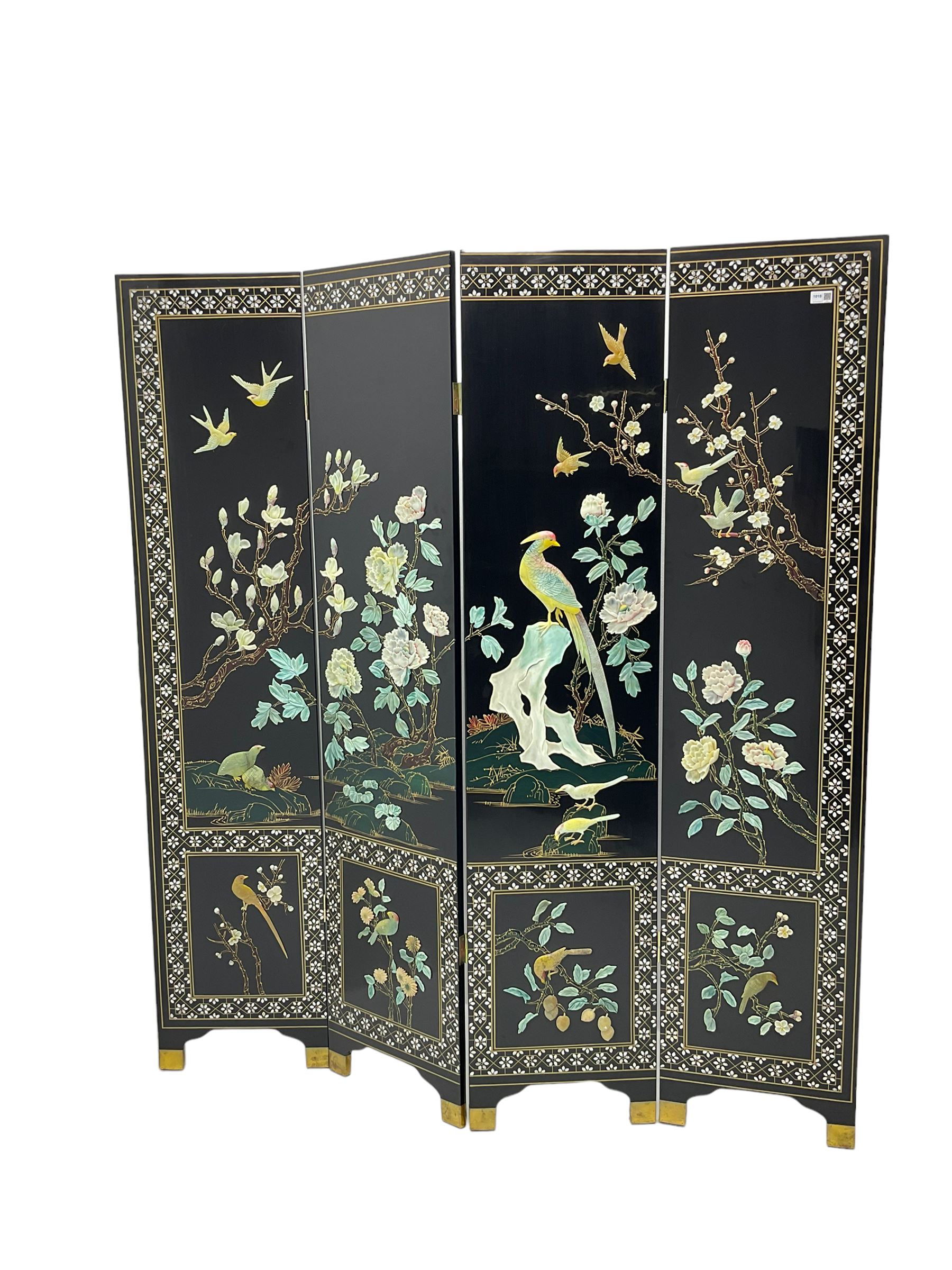 Japanese Shibayama style black lacquered four panel folding screen, naturalist scenes of trailing branch and blossom flowers, decorated with with birds, floral mother of pearl inlaid borders