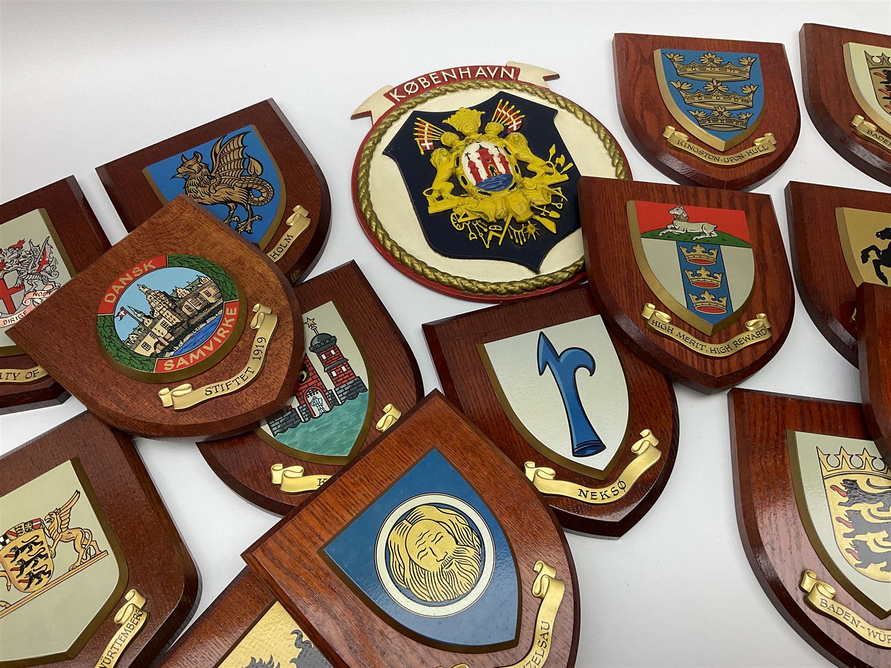 Various European cities and states, wooden heraldic shields each with hand painted raised shield including Baden Wurttemberg, Kunzelsau, City of London, Kingston upon hull etc, seventeen in total. . 