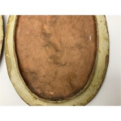 Pair of 19th century classical terracotta relief wall plaques depicting the goddess Hygeia and another goddess, seated holding an ewer, each of oval form, indistinctly signed, each stamped Ferreira verso, H42cm, W30cm