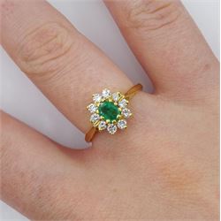 18ct gold oval emerald and round brilliant cut diamond cluster ring