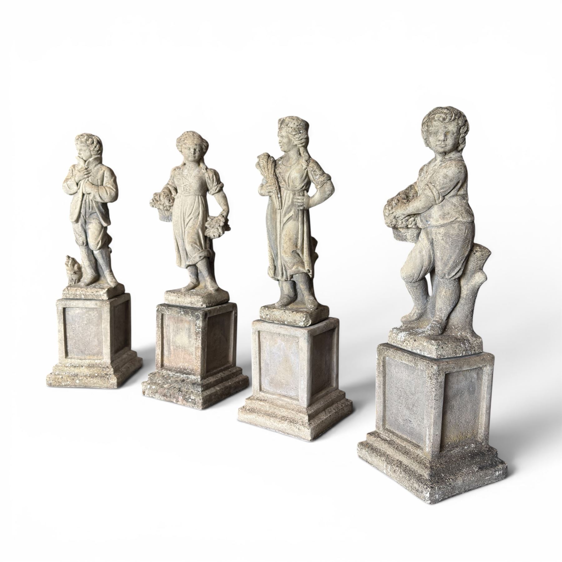 The Four Seasons - set of four traditional cast stone garden figures, in a weathered finish, stamped 'Lucas'