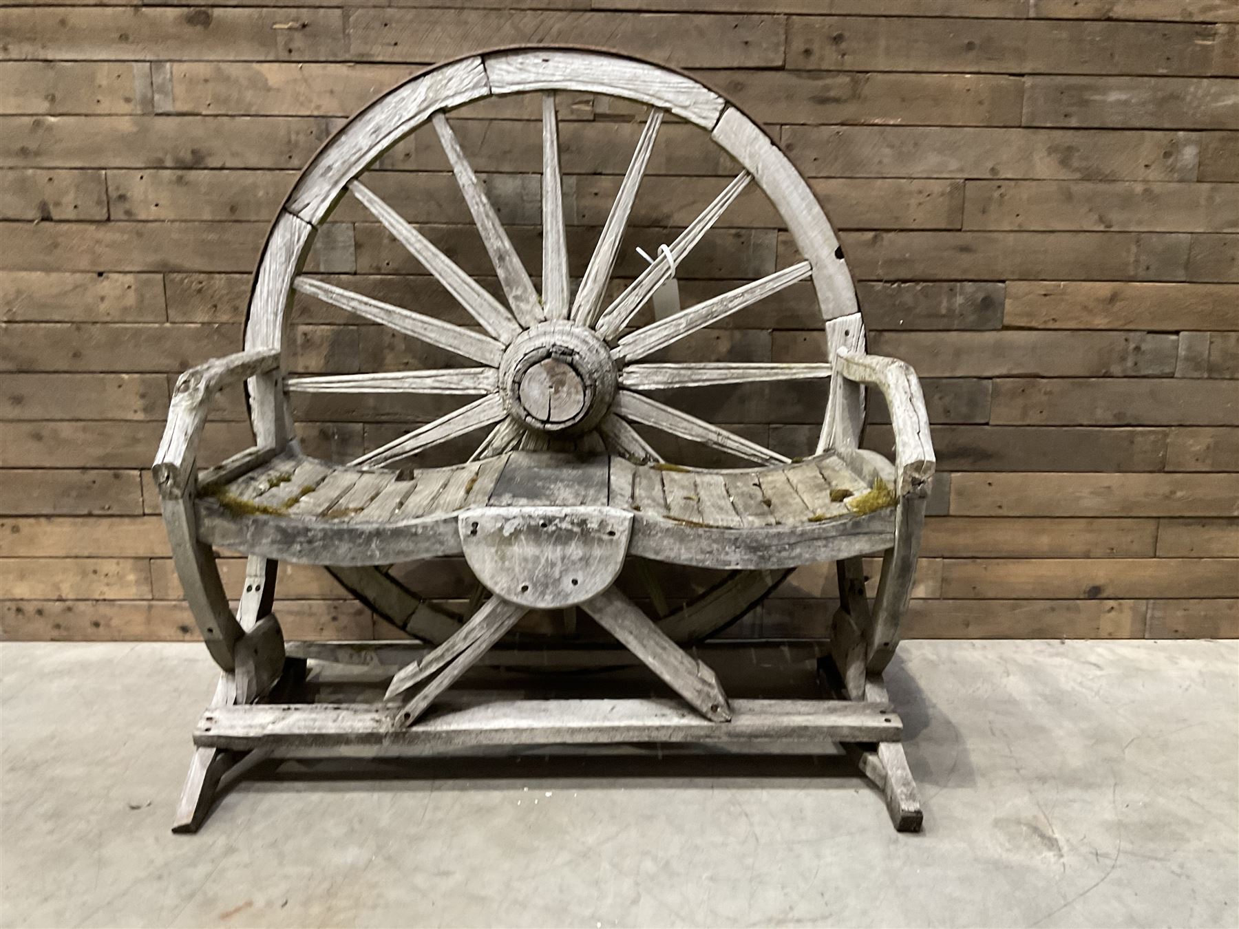 Early 20th century timber framed cartwheel garden bench