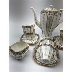 An Art Deco Shelley Queen Anne shape coffee set for six decorated in the Fruit Border pattern, pattern number 1563, comprising coffee pot, cream jug, open sucrier, teacups and saucers. 
