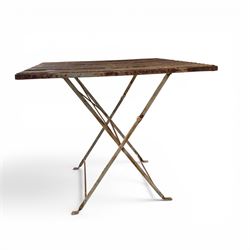 Pair of French 1920's wrought metal folding bistro café tables, the strapwork top over a folding X-frame base, in rustic white painted finish
