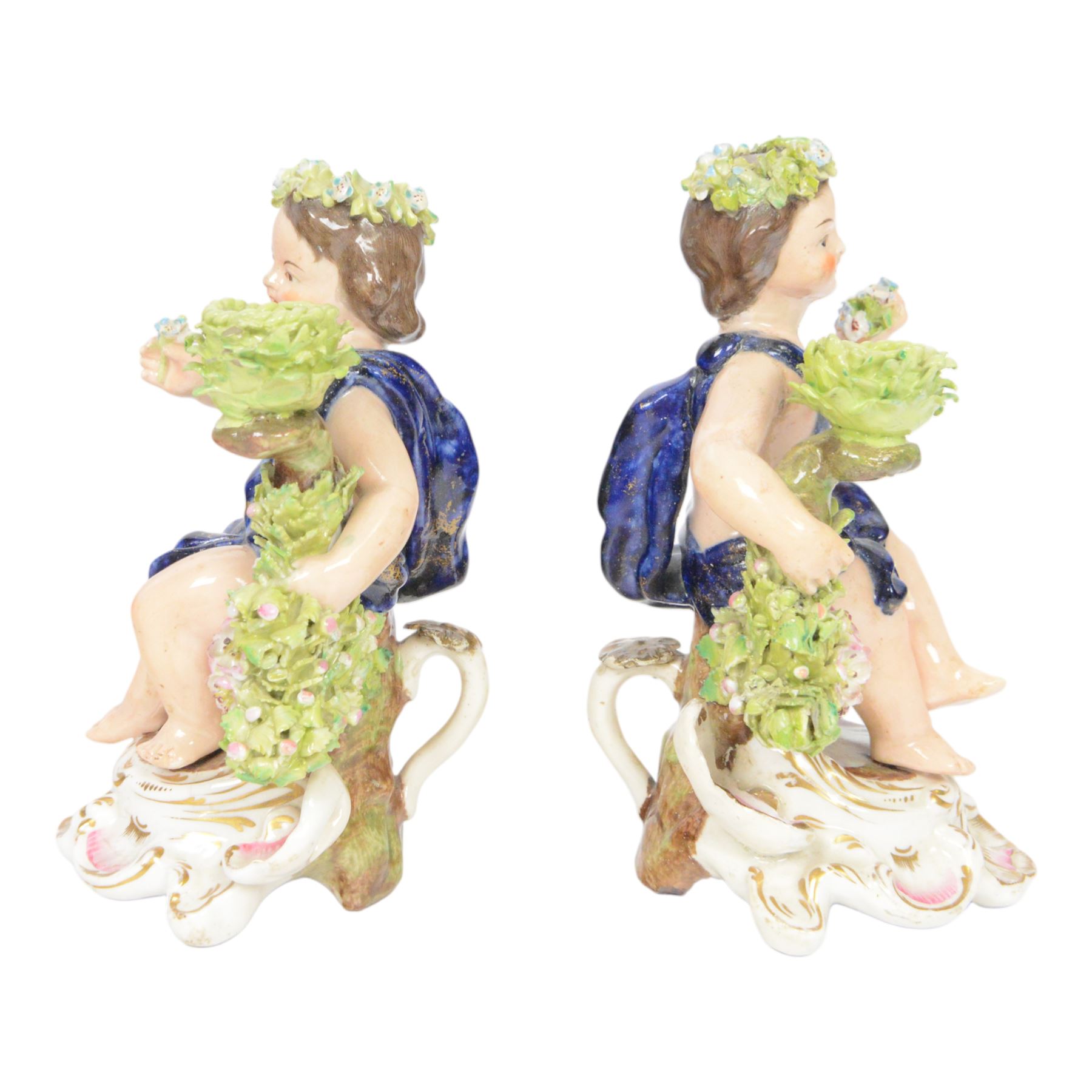 Pair of 19th century Stevenson and Hancock Derby figural chambersticks, each modelled as a seated cherub with arm around foliate encrusted sconce, marked beneath, H18cm