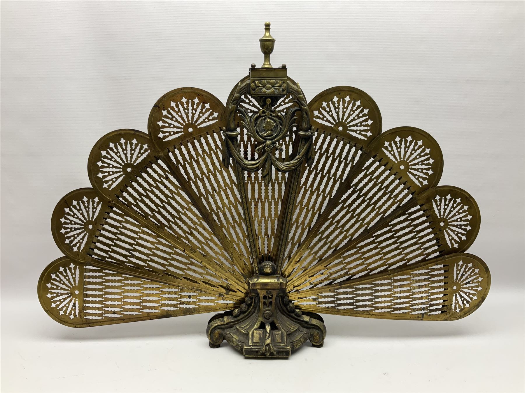 Pierced brass peacock style folding fire screen, with urn finial, H65.5cm