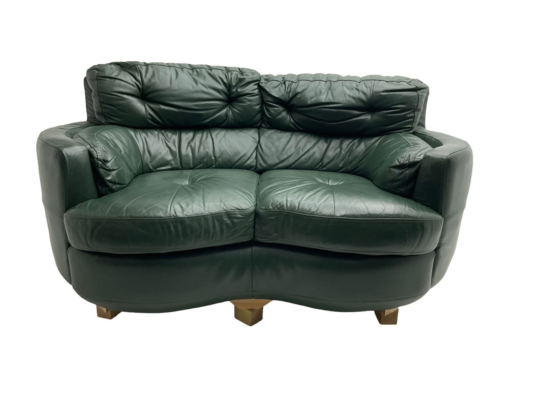 Two seat serpentine sofa, upholstered in green buttoned leather