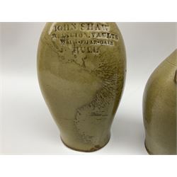  19th century salt glazed stoneware gin bottle impressed John Shaw, Red Lion Vaults, Whitefriargate, Hull of bulbous oval form H27cm and another with impressed label for J. Christie Mytongate Hull (2)  