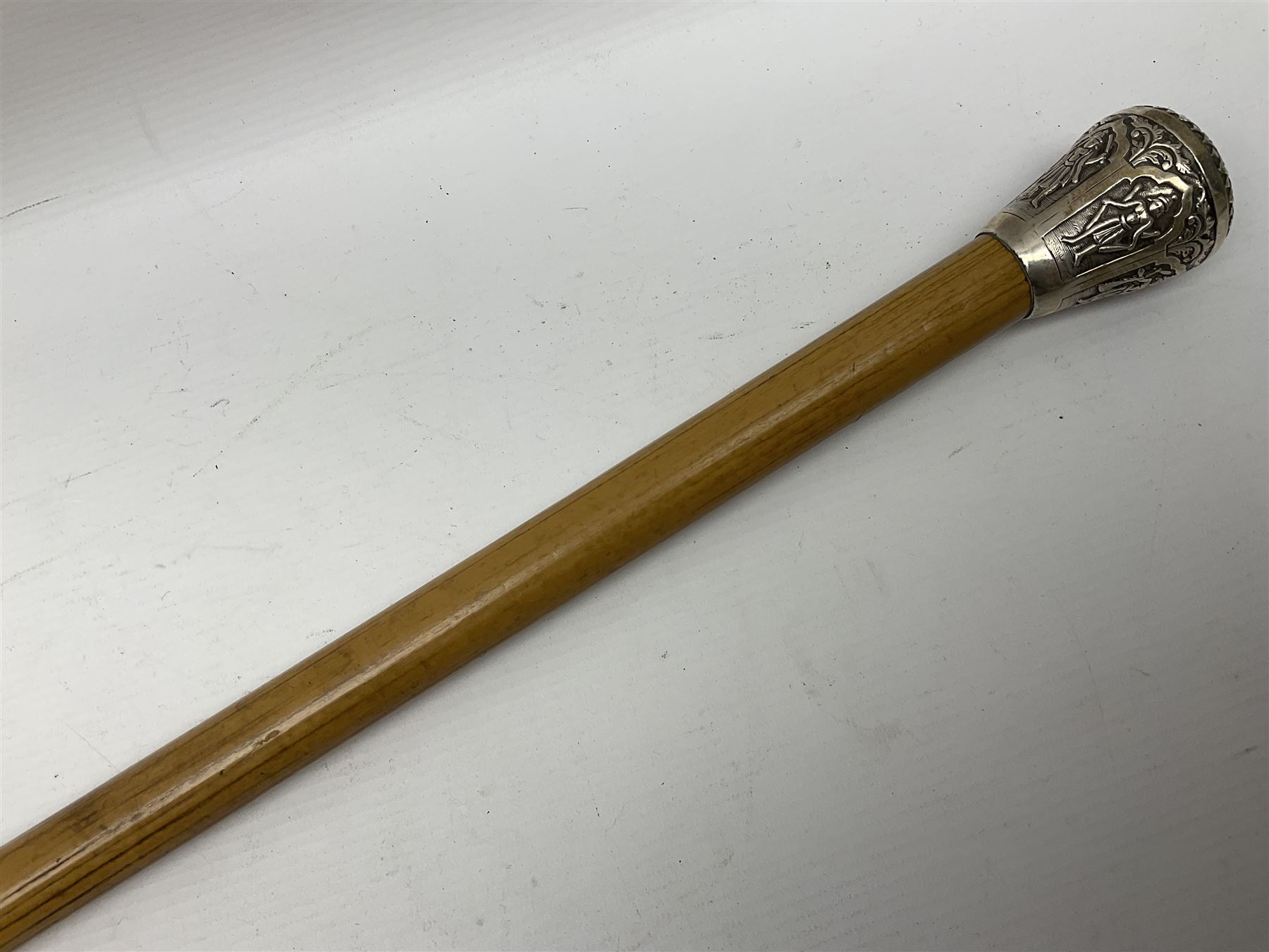 Malacca walking cane, with domed Burmese silver pommel embossed with deities, L91.5cm