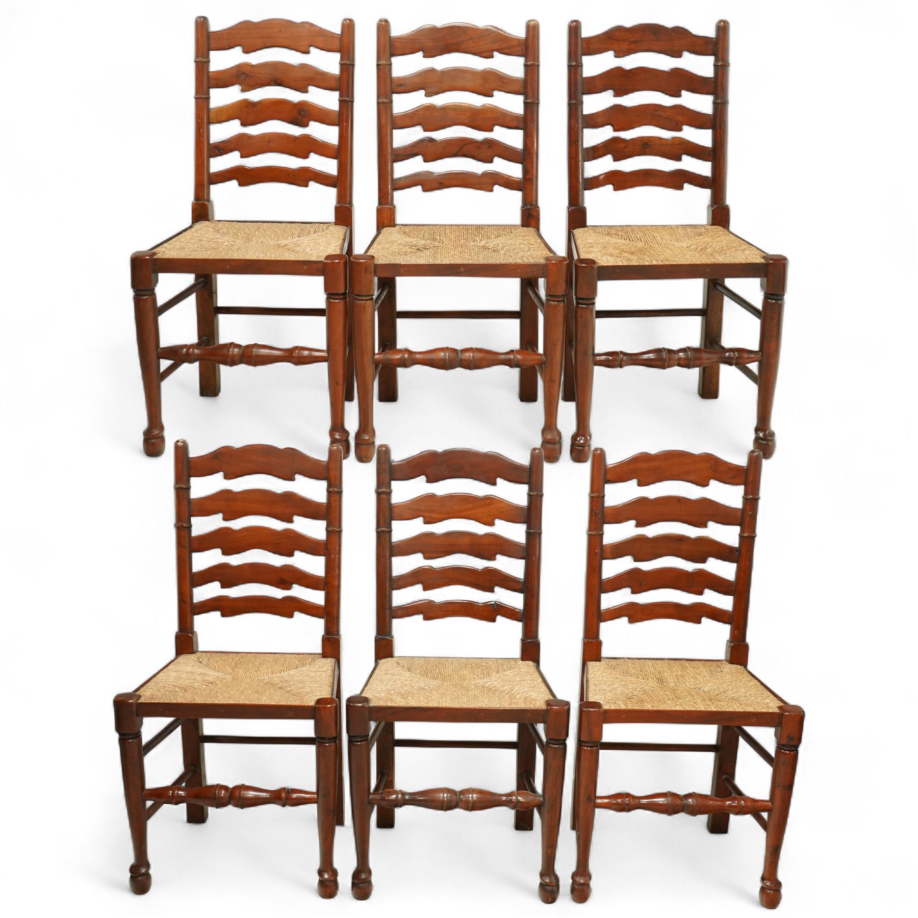 Mid-20th-century set of six elm ladderback chairs, with rush seat and five shaped horizontal back splats, turned front legs, and stretchers 