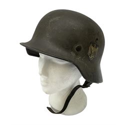 WW2 German single decal combat helmet, possibly M35, with liner and strap; impressed to skirt EF62 and 700