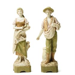Pair of Royal Dux figures of agricultural workers modelled by Alois Hampel, one holding a ...