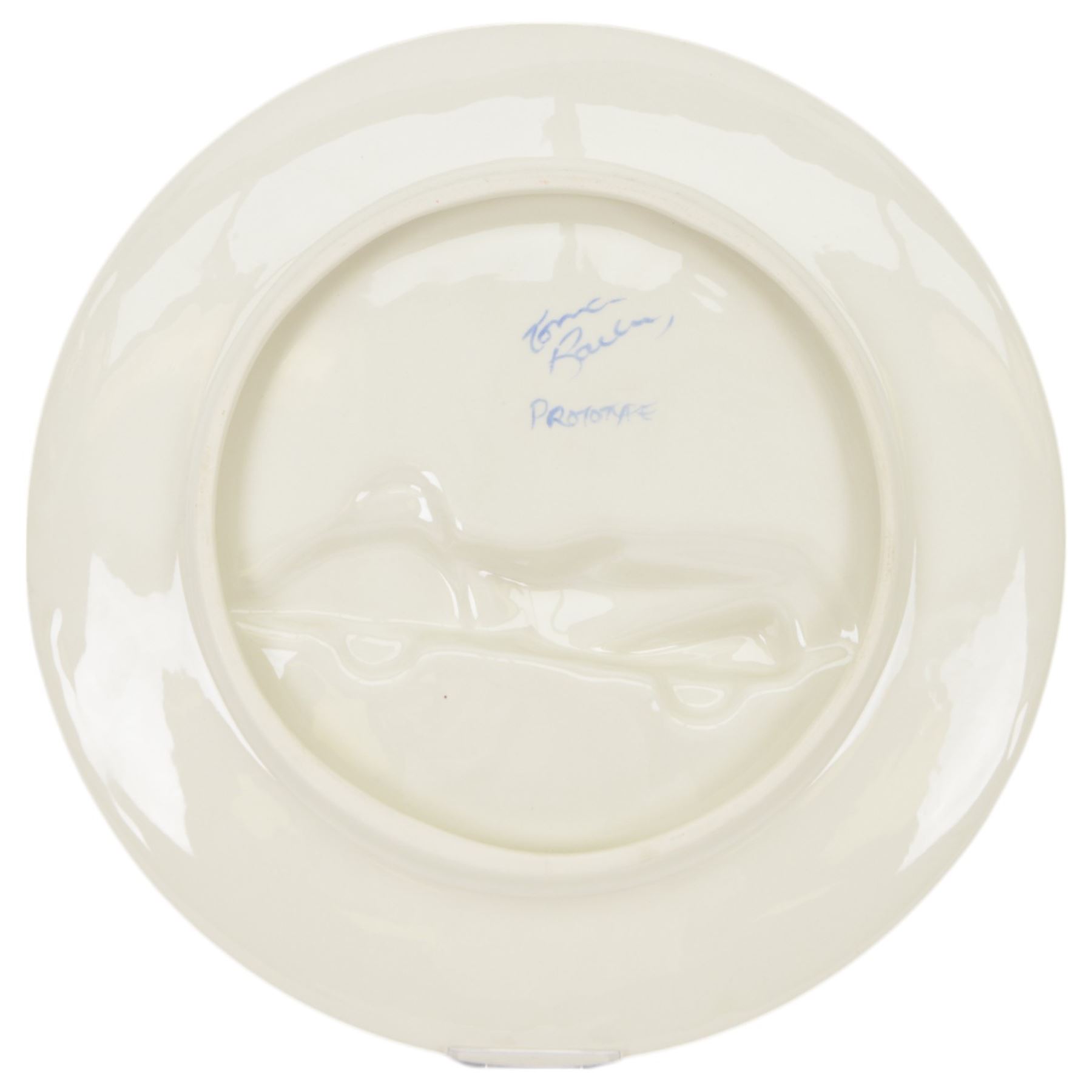 Lorna Bailey prototype charger, decorated with a race car in relief within bright stylised landscape, signed verso, D34.5cm
