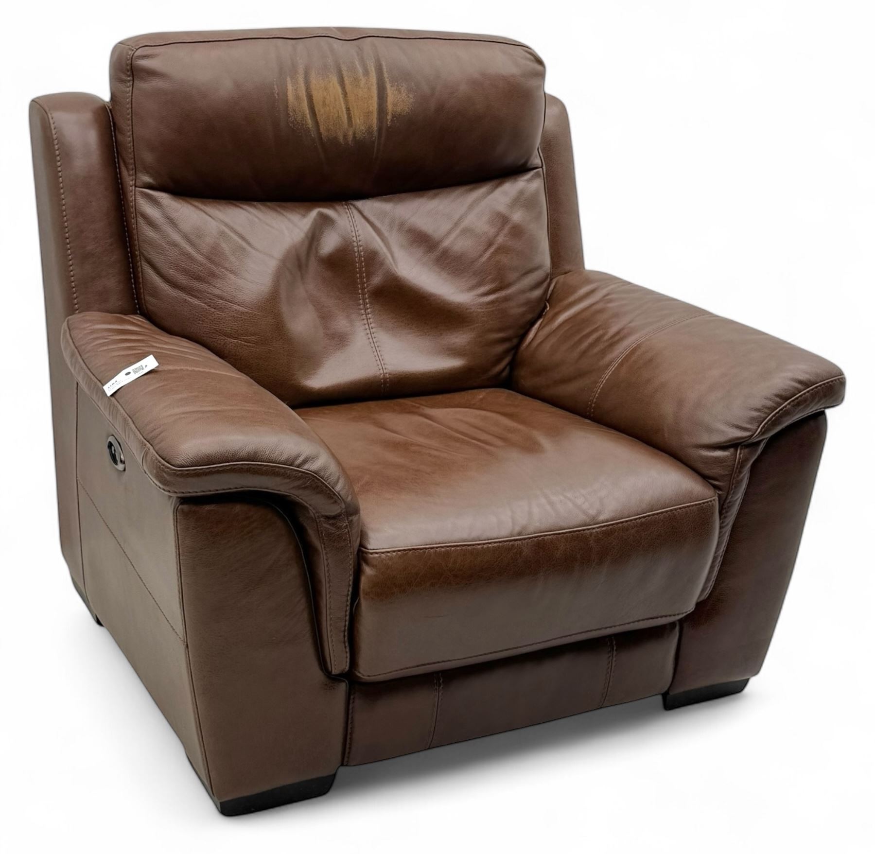 DFS - 'Liaison' reclining armchair upholstered in brown leather, upholstered in tan leather with stitched panel backrest and generously cushioned seat and arms, operated by wired remote, raised on block feet