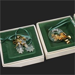Twelve Swarovski crystal 'Christmas' and 'Crystal' Memories ornaments, comprising Moon, Sun, Boot, Candy Cane, Christmas Wreath, Pinecone and Holly etc, boxed and with sleeves (12)