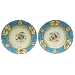  Pair early 20th century Minton plates hand painted with floral sprays by M. Dudley, within a raised gilded border of floral swags and scrolls on turquoise ground. This part service was made for export to America in 1916 as a wedding gift, the reverse painted with gilded monogram, 1916 and Mintons back stamp, D25cm (2)  Provenance Property of Bob Heath, Brandesburton Formerly of Ravenfield Hall Farm near Rotherham  