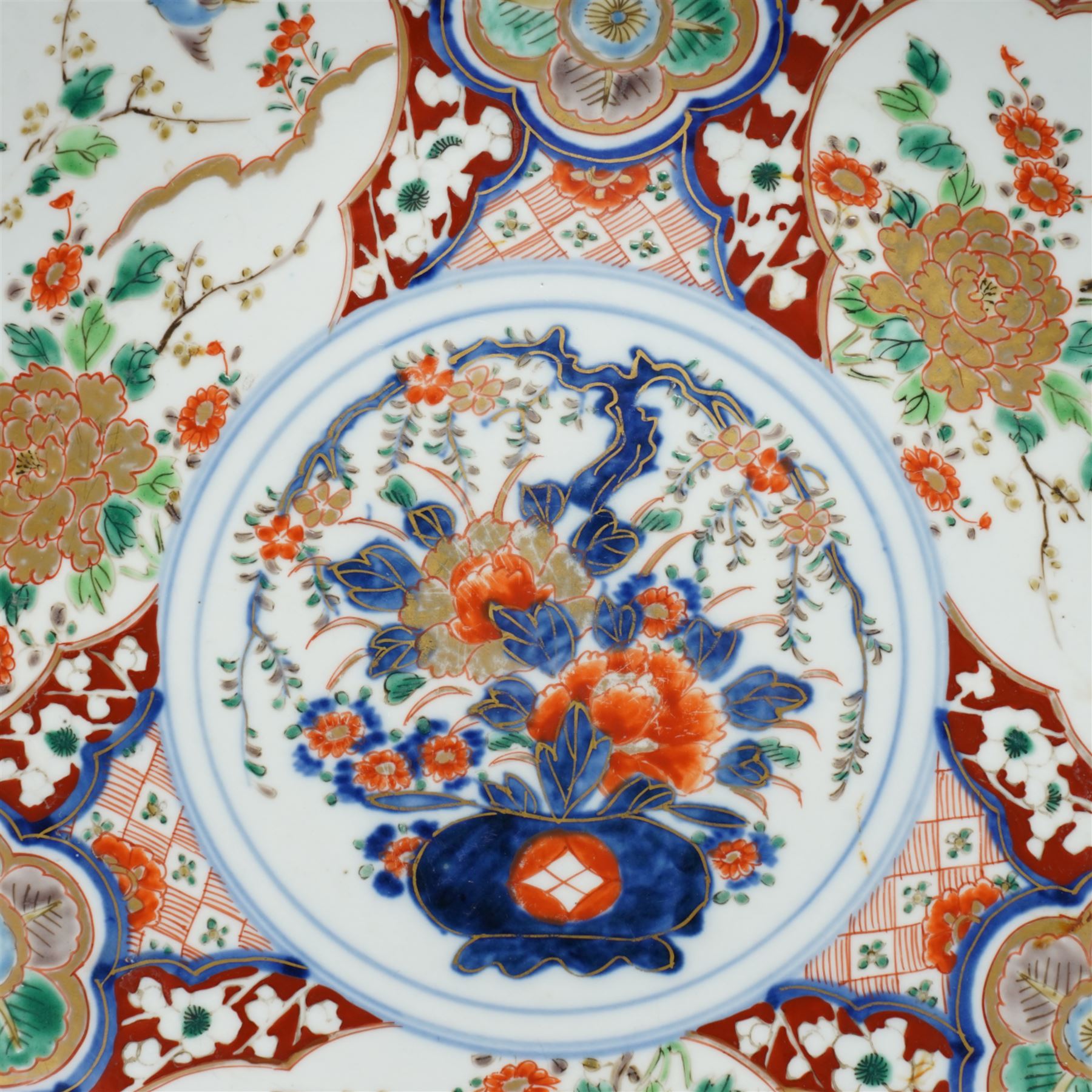 Japanese Imari charger decorated with panels of birds and flowers in orange, blue and red etc D37cm and two smaller Imari plates D21cm (3) 
