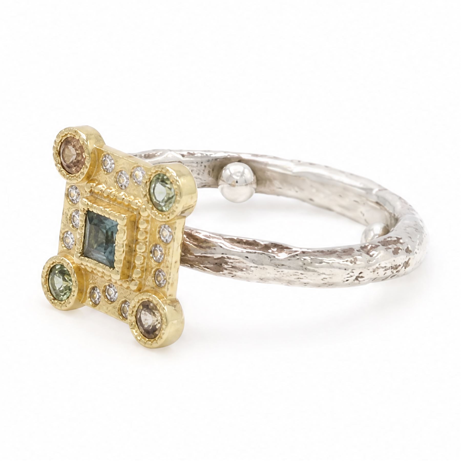 18ct gold and silver blue topaz, sapphire diamond dress ring, square cut blue topaz, surrounded by round brilliant cut diamonds, the corners set with green and orange / brown sapphires,stamped 18K 925