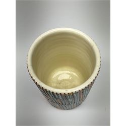 A Poole Pottery Delphis vase, shape 83, with textured effect in merging tones of red, yellow and blue, with printed mark beneath, H15cm.