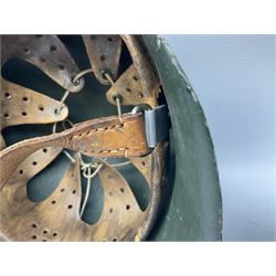 Fully restored German steel helmet, the camouflage painted exterior with two decals and replacement leather liner