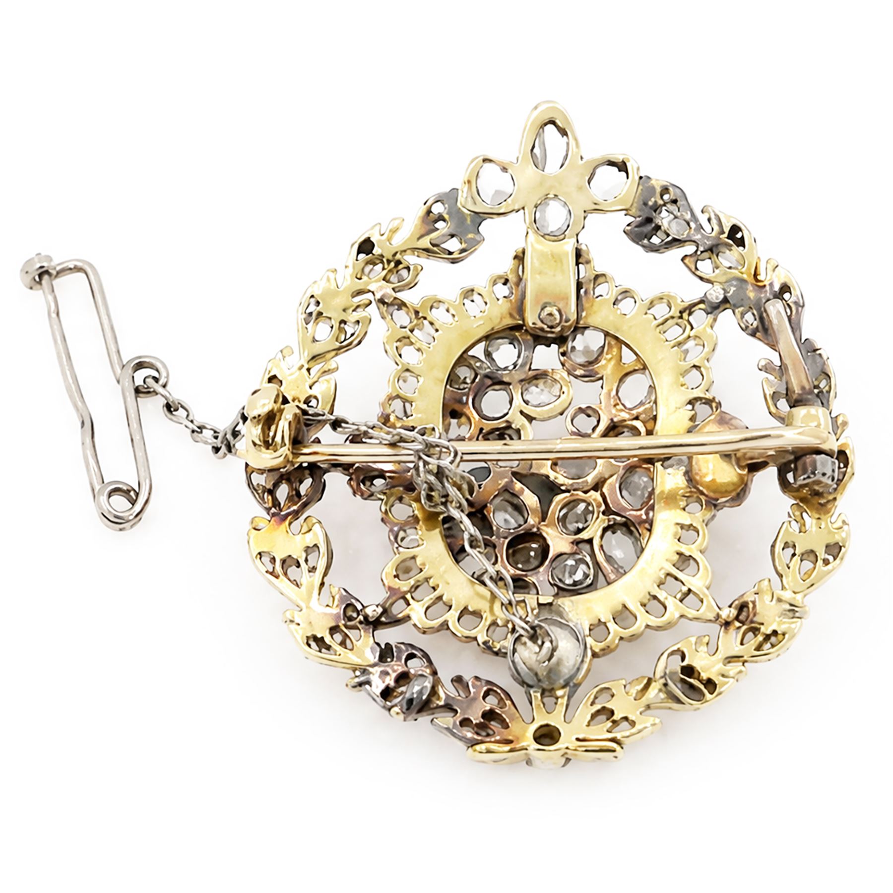 19th century floral spray diamond brooch, three central flower heads set with rose cut and old cut diamonds within an sunburst surround and outer wreath border, set with further rose cut diamonds 