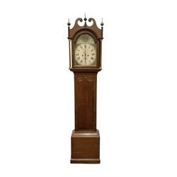 Early 19th century oak cased eight-day longcase clock c1810 - with a swan necked pediment and three matching brass finials, break arch hood door flanked by turned pilasters with brass capitals, trunk with a full length spire topped door on a square plinth with applied skirting, early painted dial with Roman numerals, Arabic five minutes, subsidiary seconds and date dials and steel hands, with floral spandrels and conforming decoration to the arch, dial pinned via a false plate to a rack striking movement, sounding the hours on a bell. With weights pendulum and key.